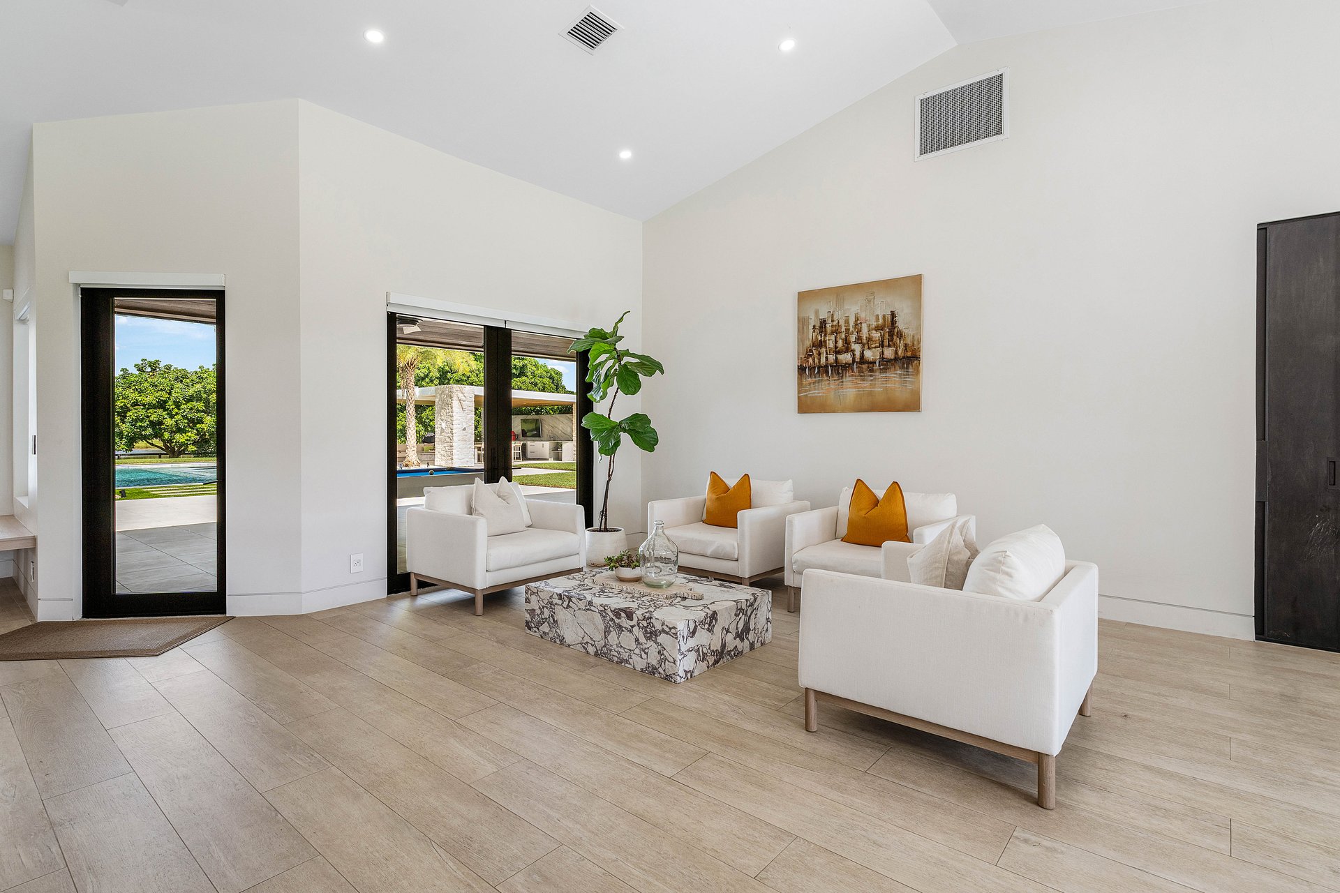 Great room with soaring ceilings and pool views