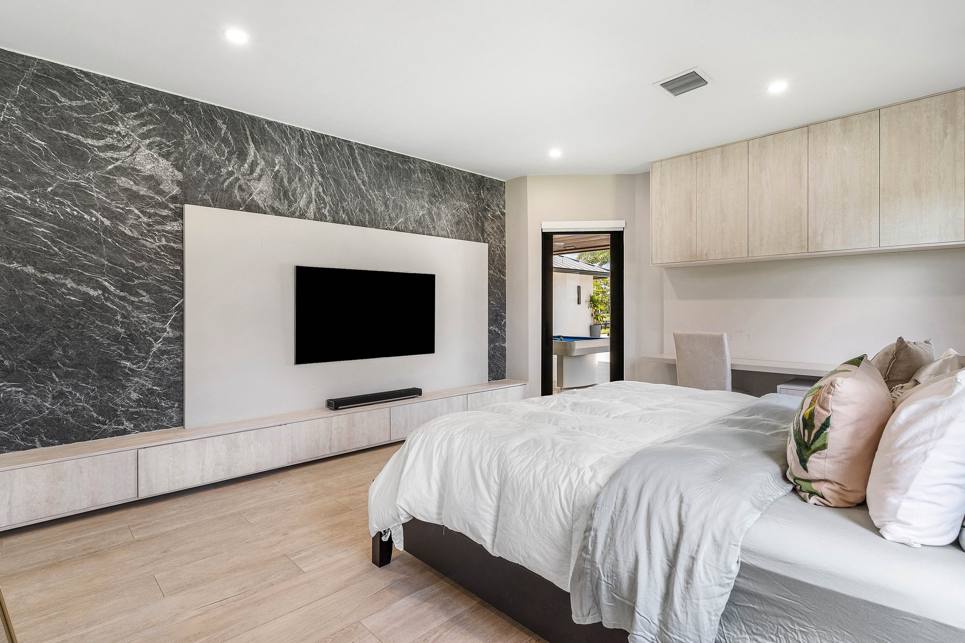 Master bedroom with stone feature wall