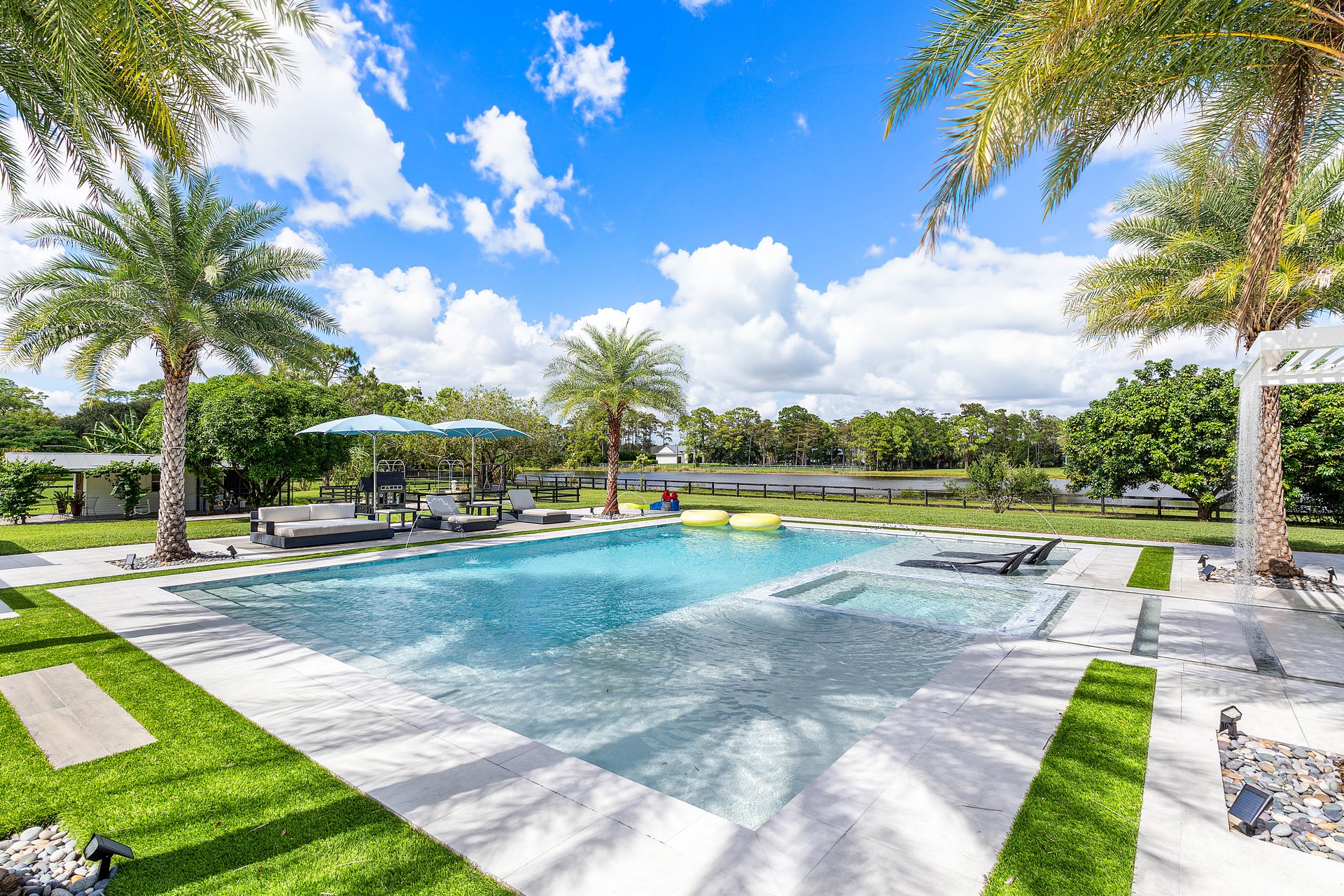 Resort pool with sunken spa and palms
