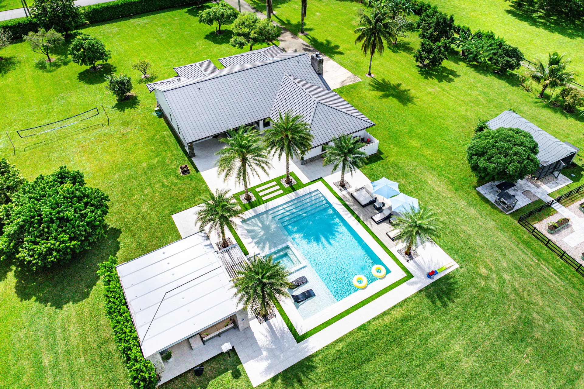 Aerial view showing pool, grounds, and lake